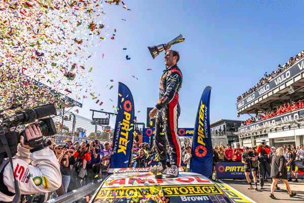 Will Brown holding the winning trophy above his head.