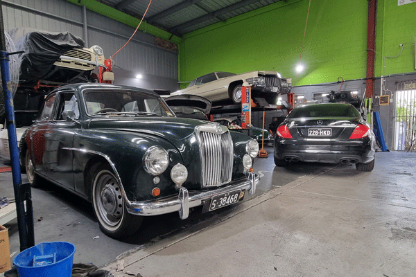 Group of cars inside mechanic workshop