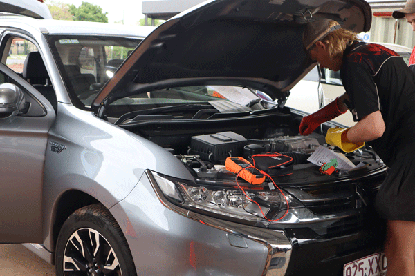 mechanic working on car engine